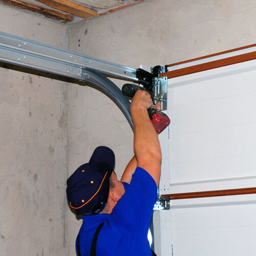 Man installing garage door springs